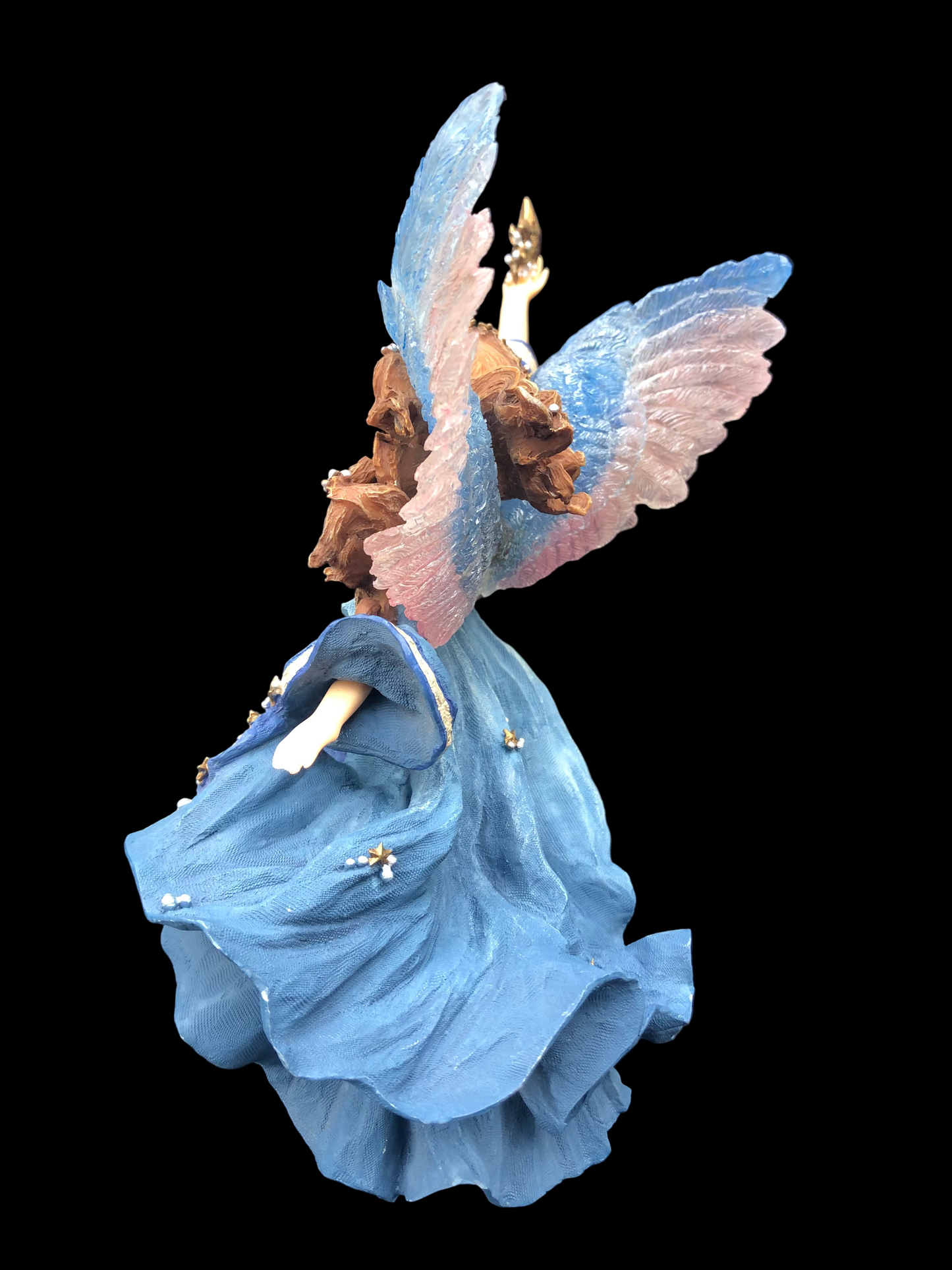 Decorative angel figurine with blue dress and pink wings on a dark background