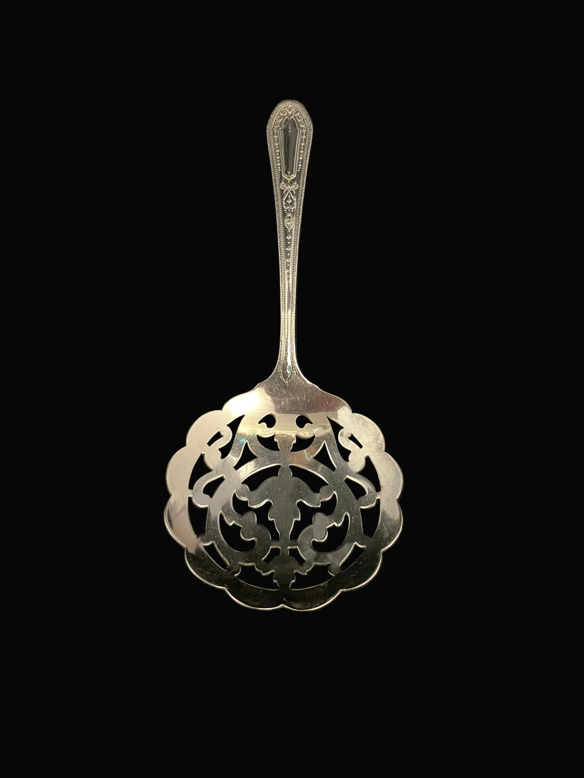 Community Plate silverplate bonbon spoon in the Hampton Court pattern, introduced in 1926.