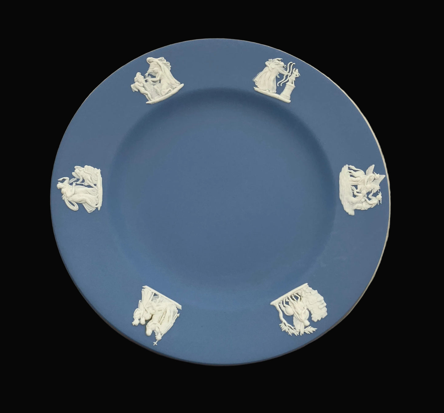 Blue plate with white decorative elements on a black background