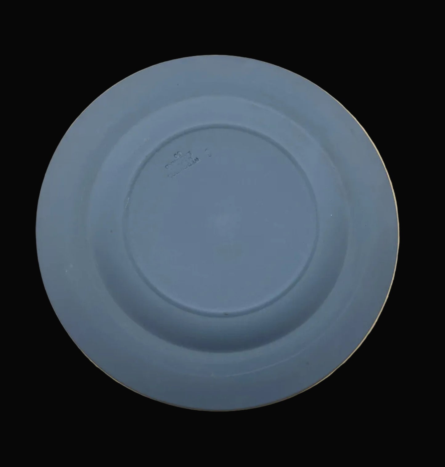 Blue ceramic plate on a black background