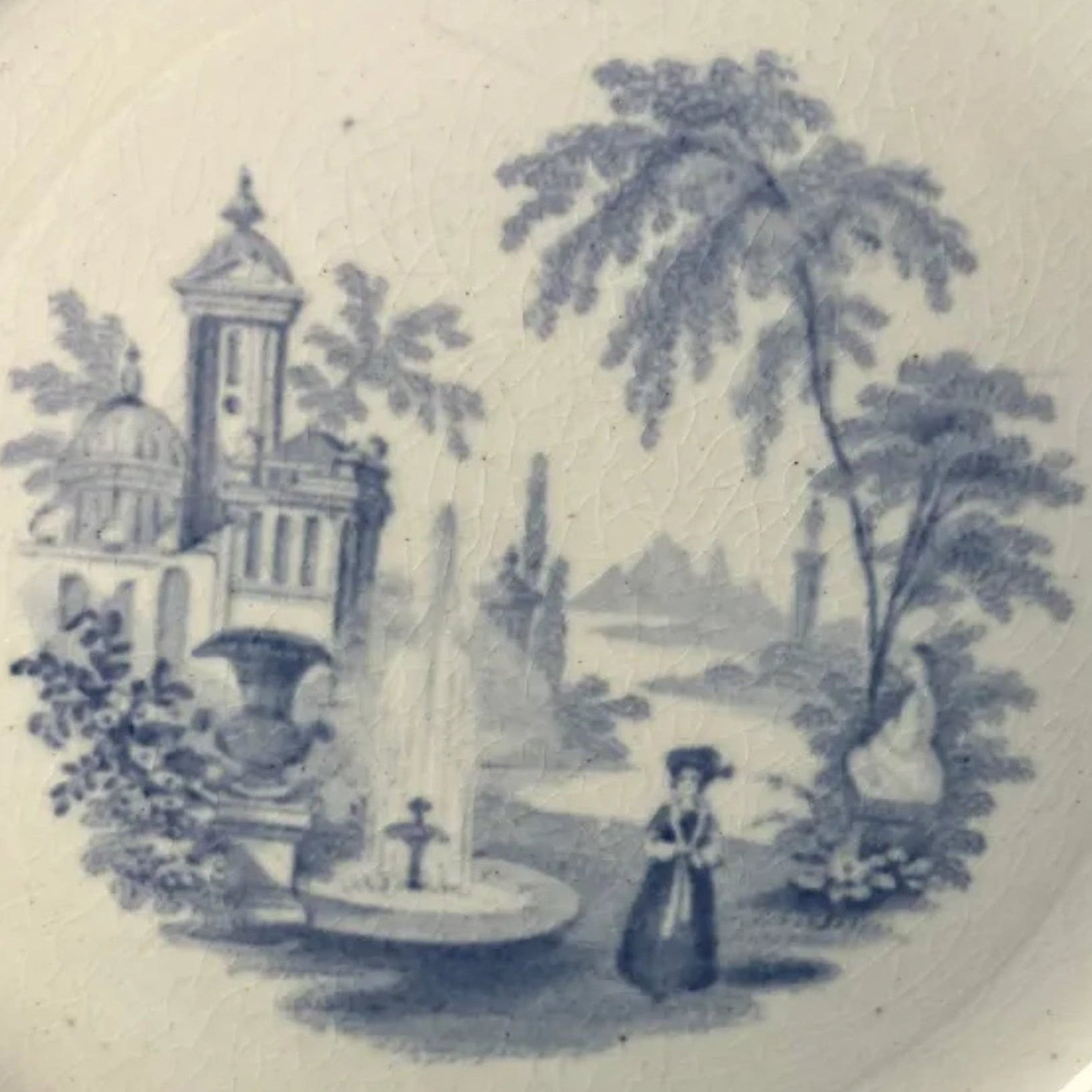 White plate with blue floral and landscape design