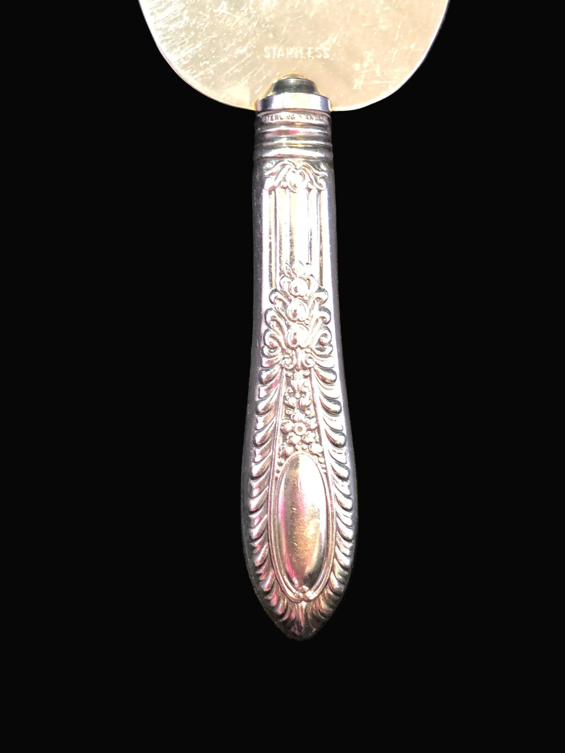 Decorative silver spoon with a black background