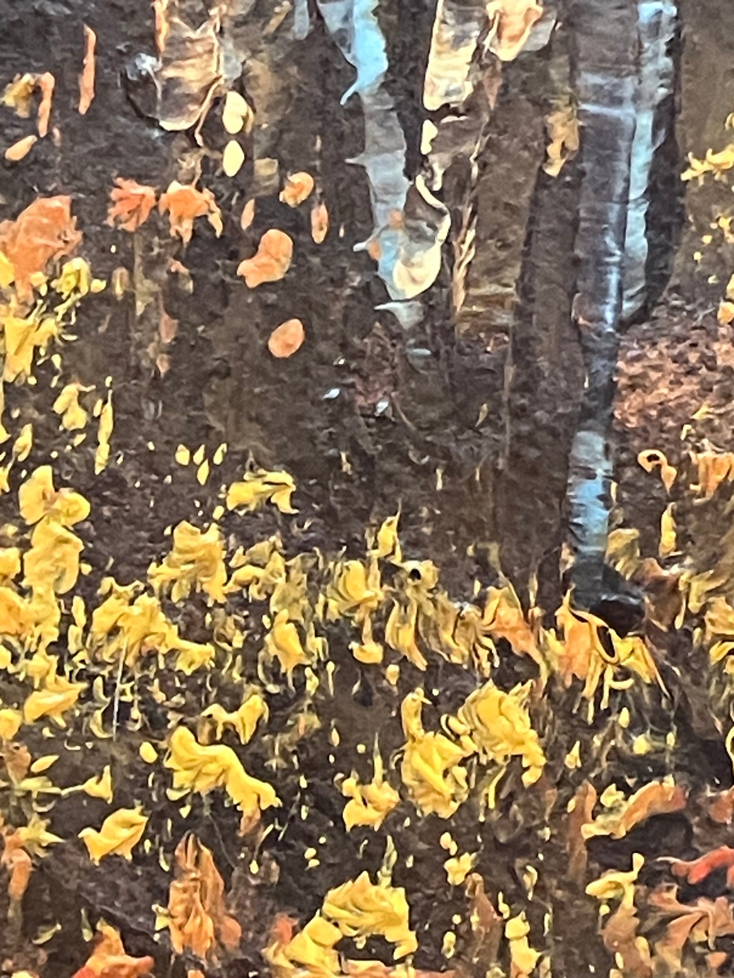 Close-up of a textured surface with yellow and orange fragments