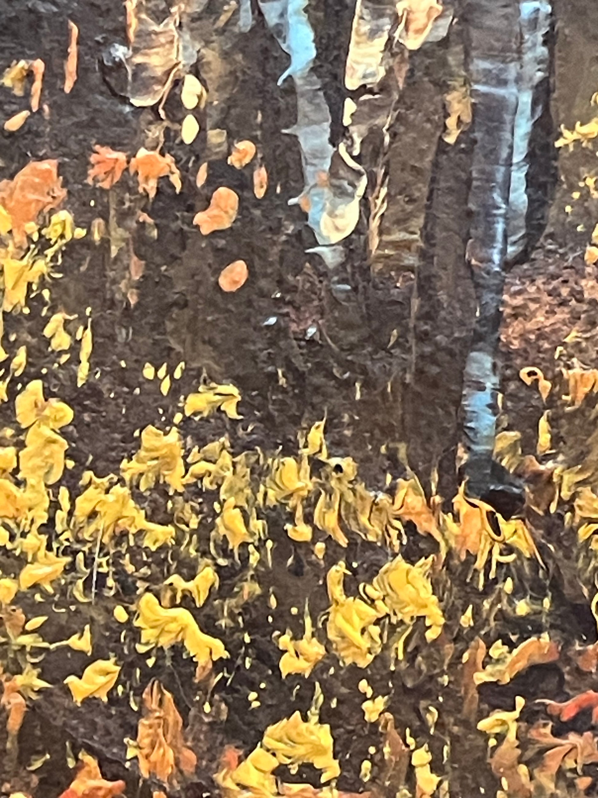 Close-up of a textured surface with yellow and orange fragments