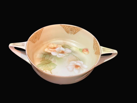 Decorative ceramic bowl with floral design on a dark fabric background