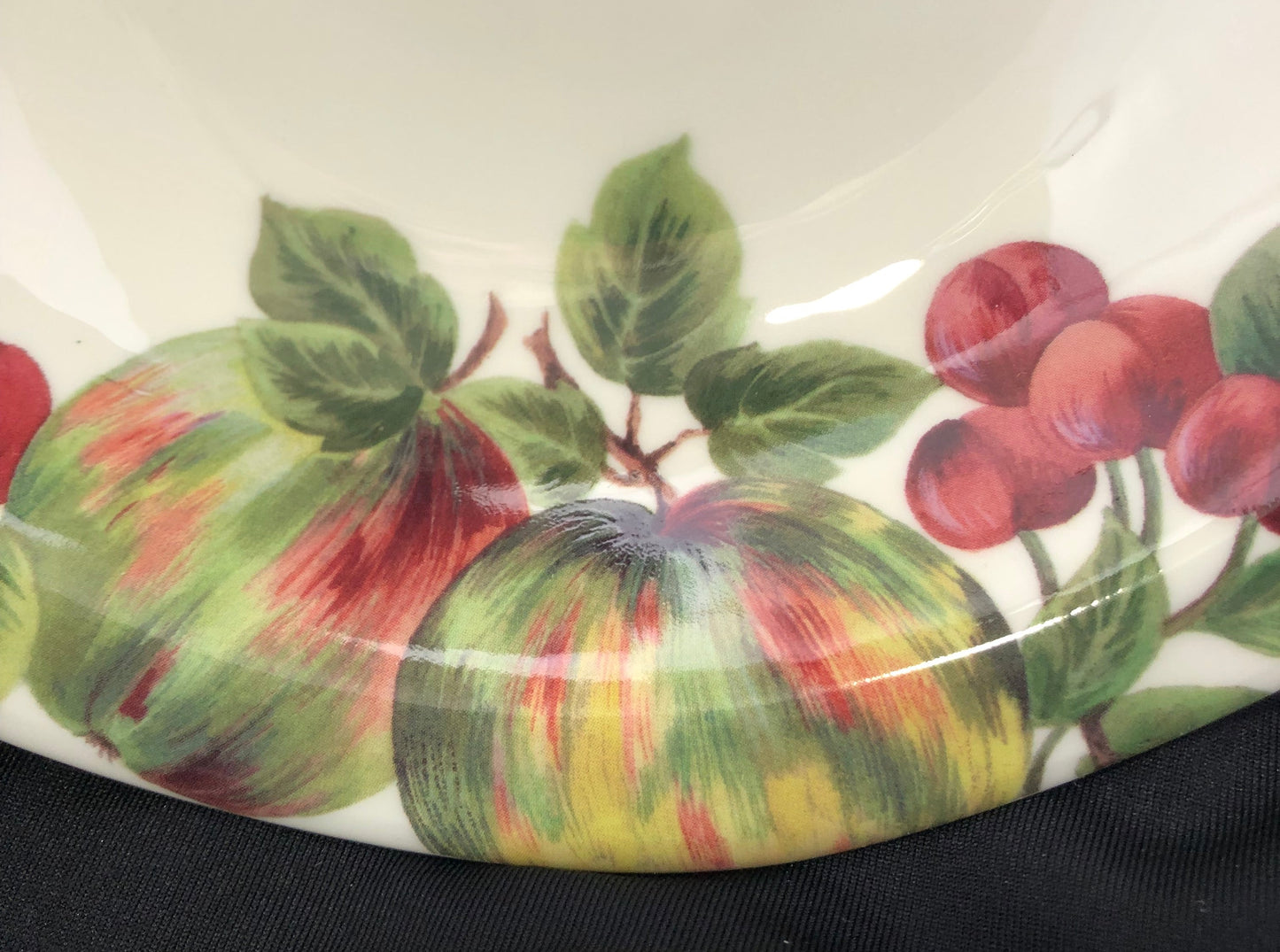 Decorative plate with fruit and leaf pattern on a white background