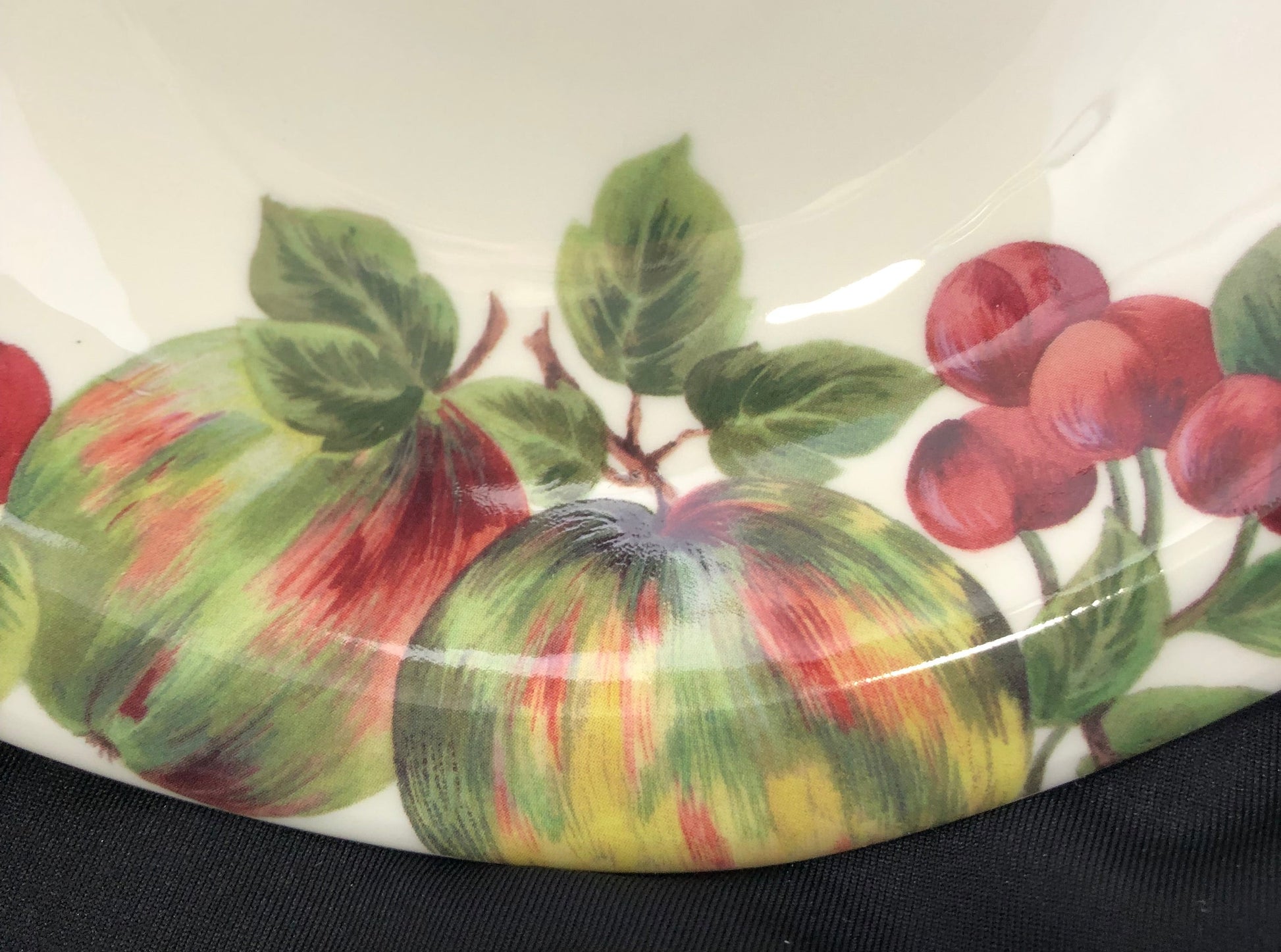 Decorative plate with fruit and leaf pattern on a white background