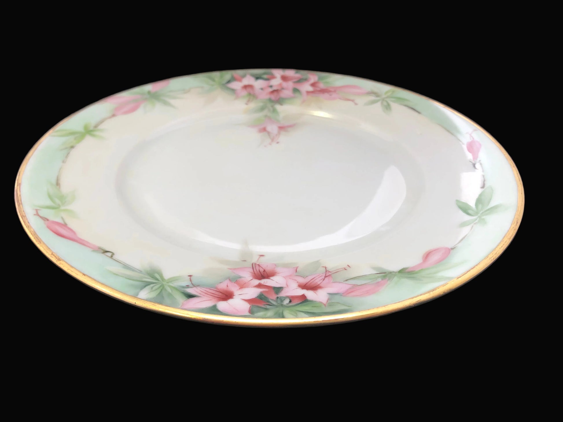 Decorative ceramic plate with floral patterns on a dark fabric background