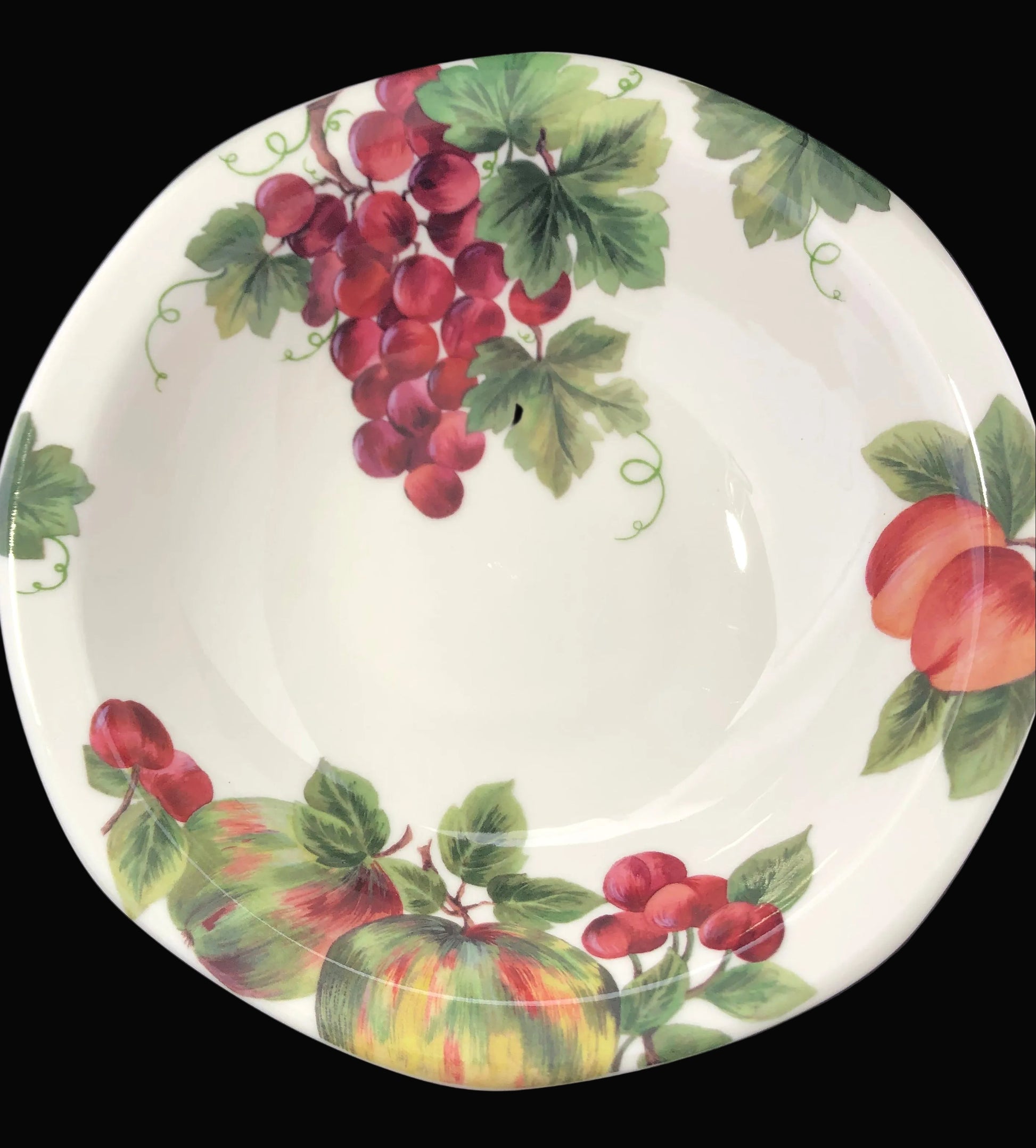 Decorative plate with fruit design on a black background