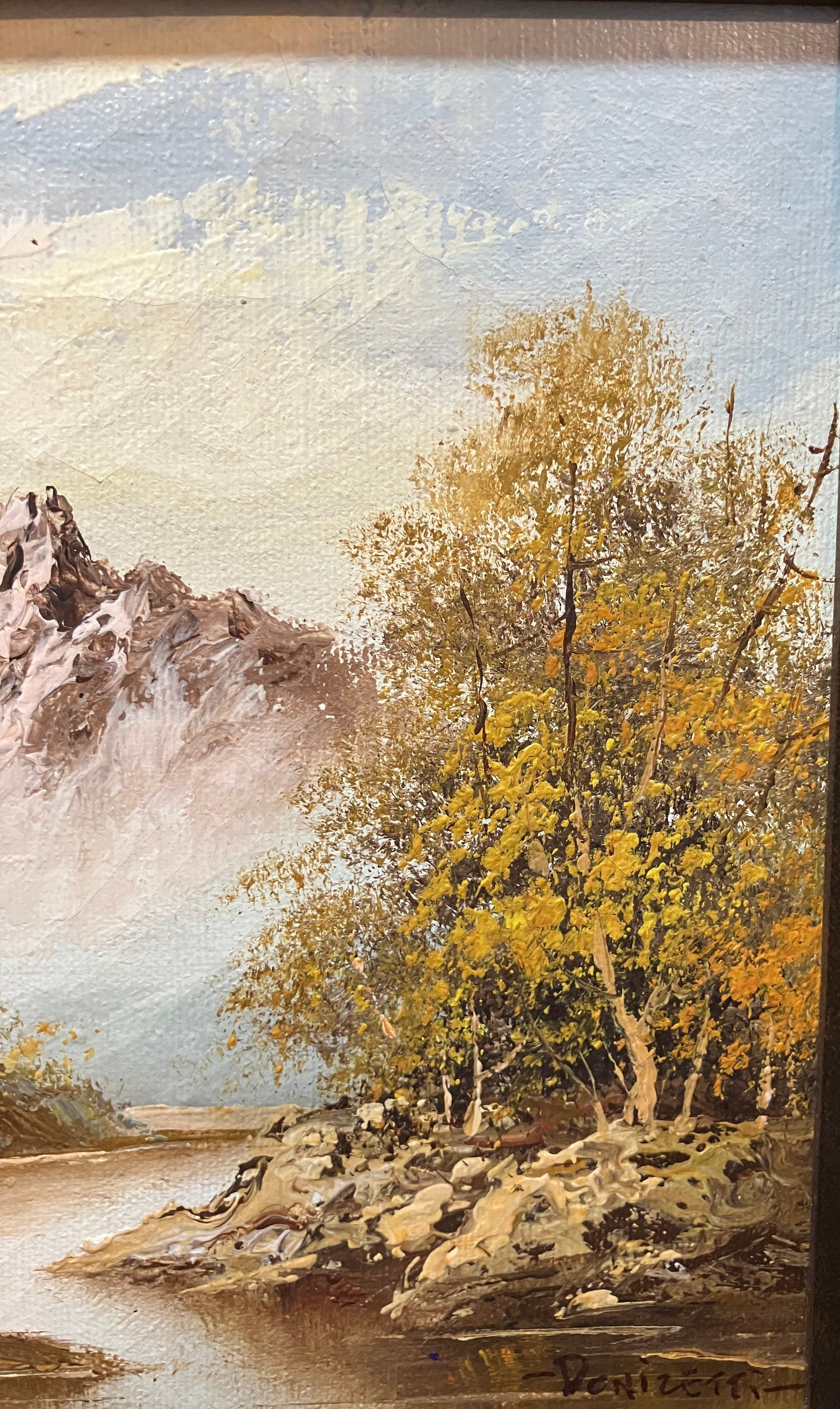 Framed artwork of a landscape with trees and mountains