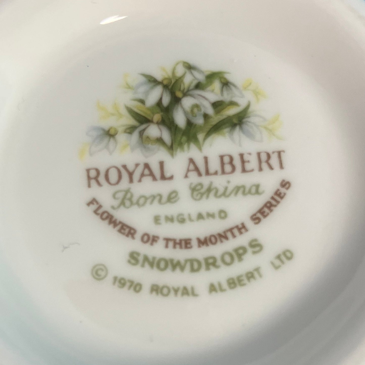 Royal Albert bone china plate with snowdrop design and branding