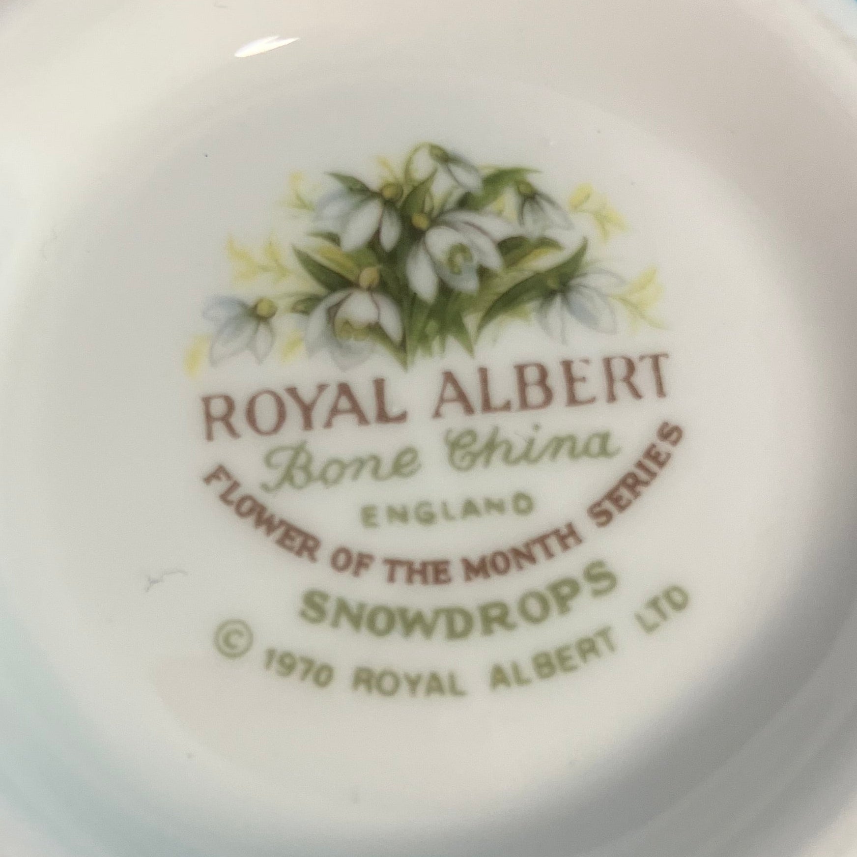 Royal Albert bone china plate with snowdrop design and branding