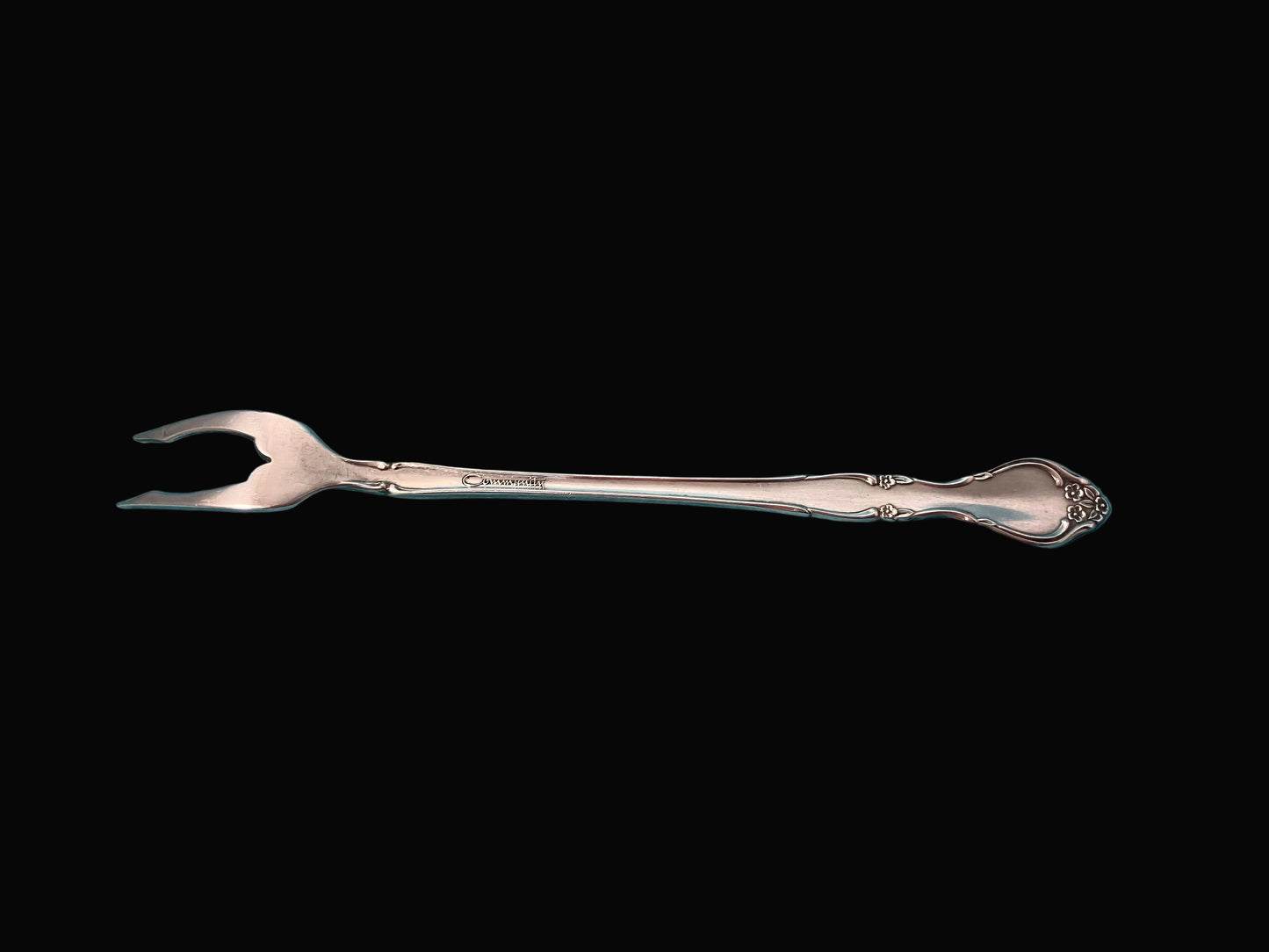 Silver fork on a black background