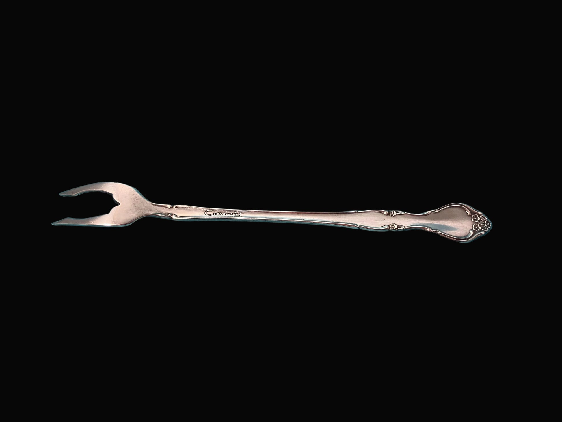 Silver fork on a black background