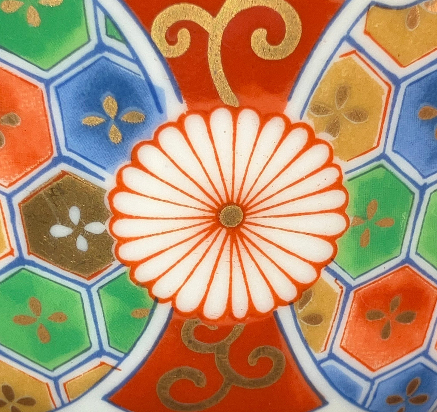 Decorative ceramic item with colorful geometric pattern on a black background