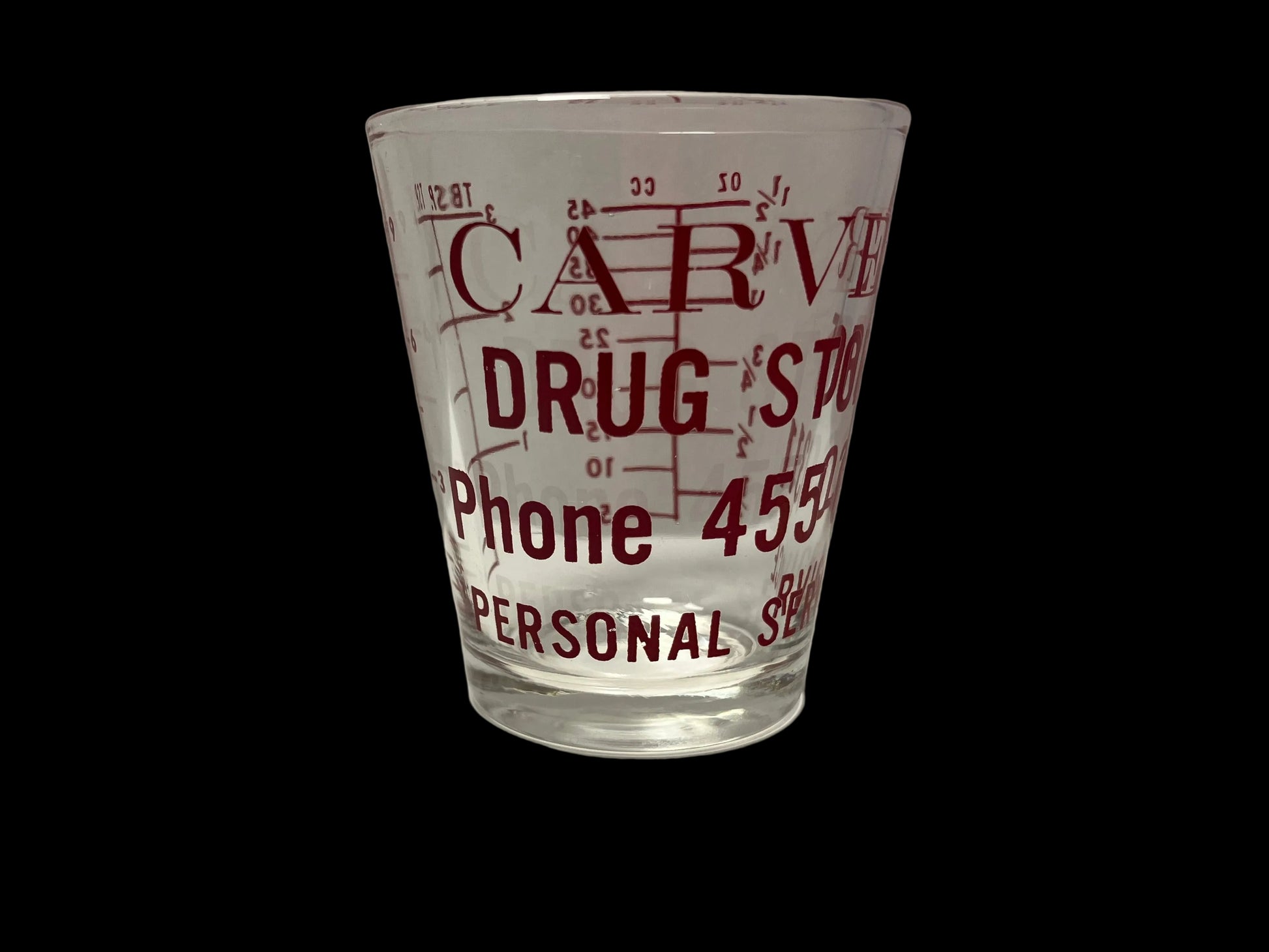 Clear glass with red text on a white background