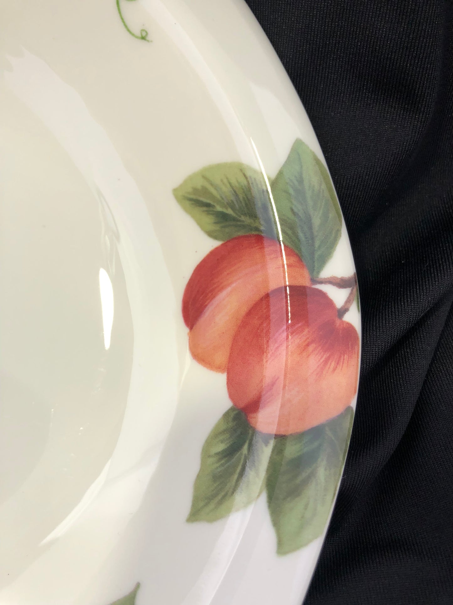 Ceramic bowl with peach design on a black background