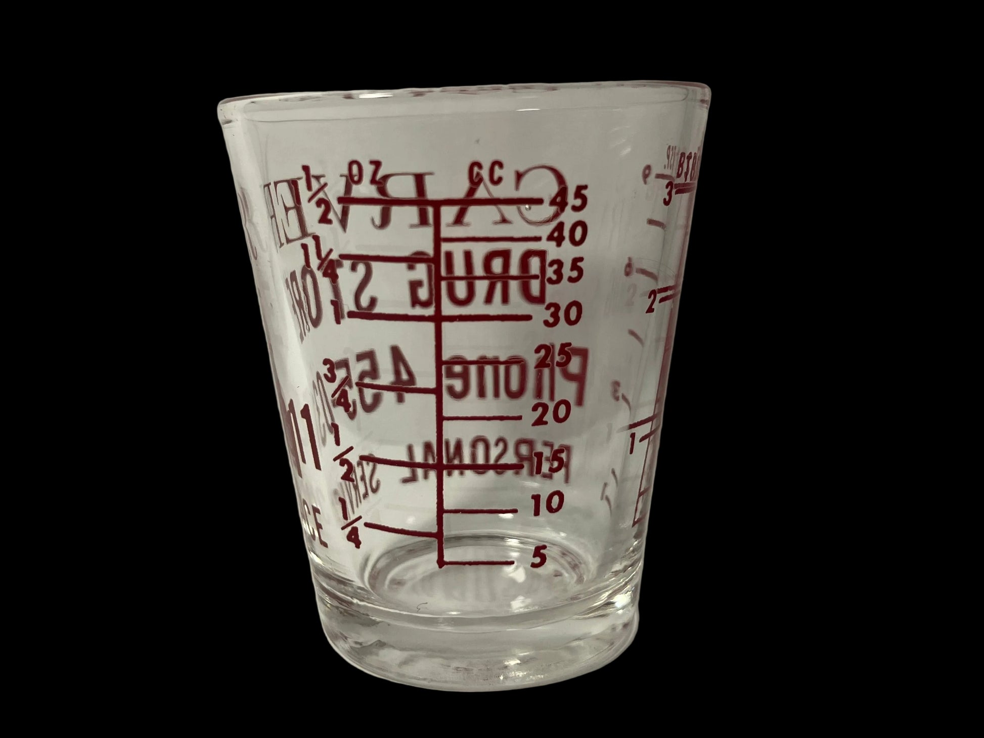 Clear glass measuring cup with red measurement markings