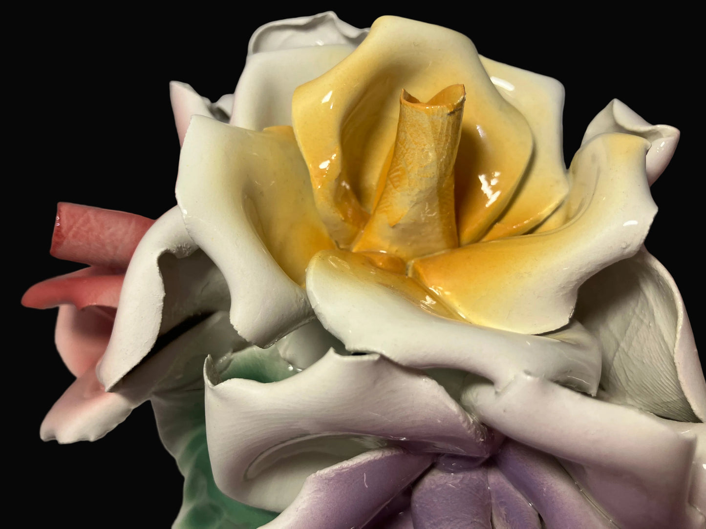 Close-up of a ceramic rose with a focus on the center.
