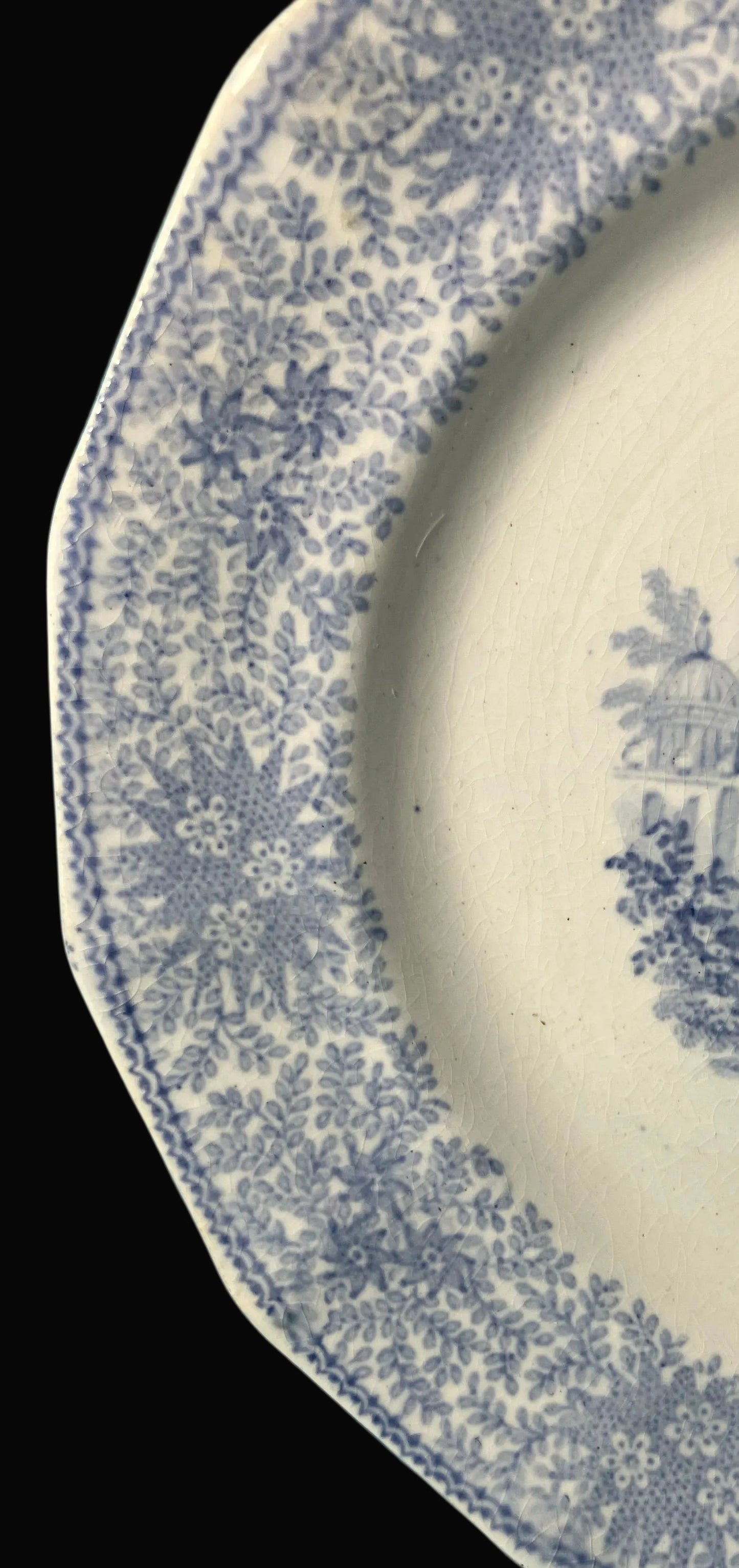 Decorative plate with blue floral and architectural design