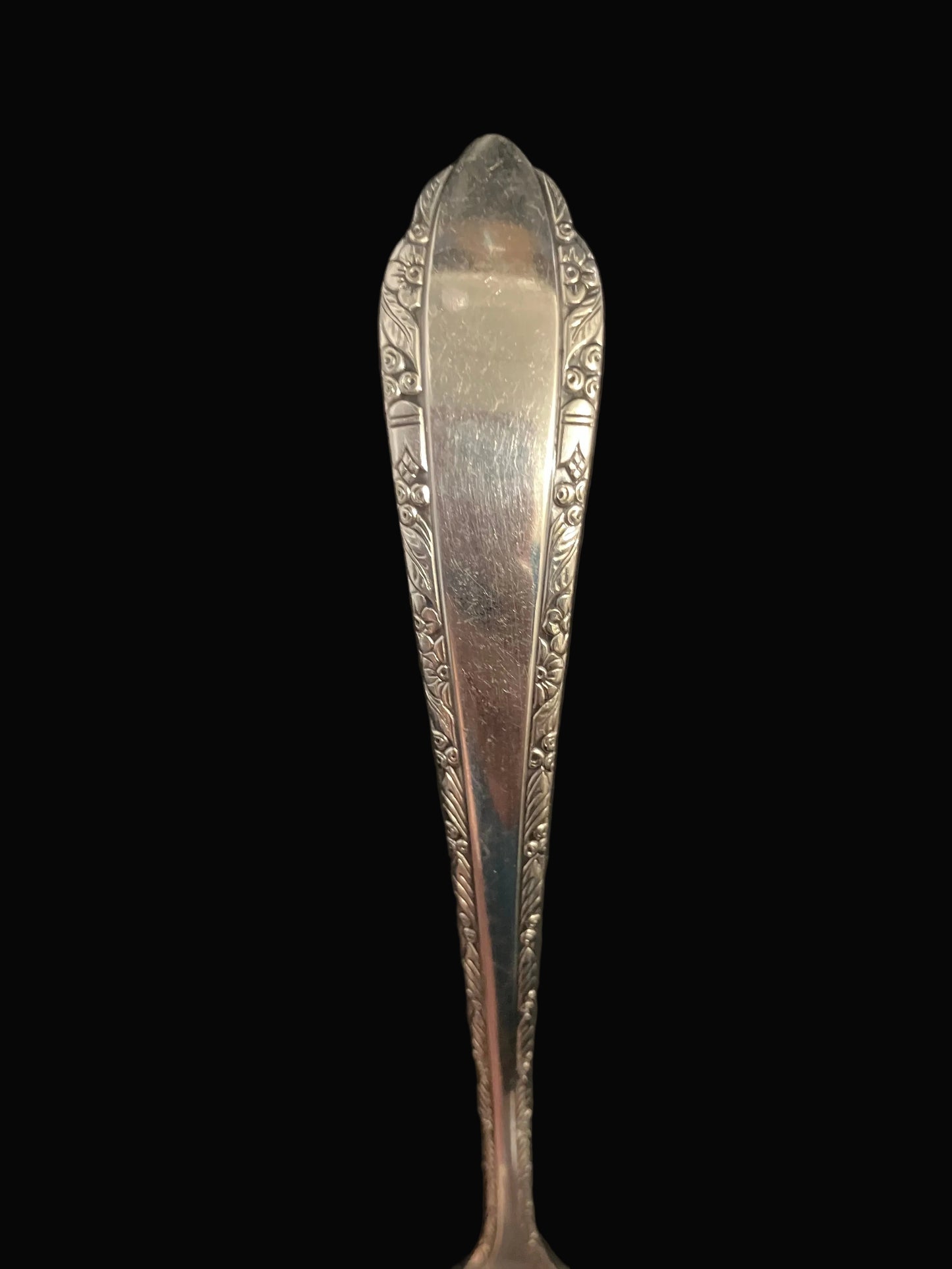 silverplate ladle features an elegant floral trim with Art Deco styling and a gracefully scalloped edge at the top of the bowl
