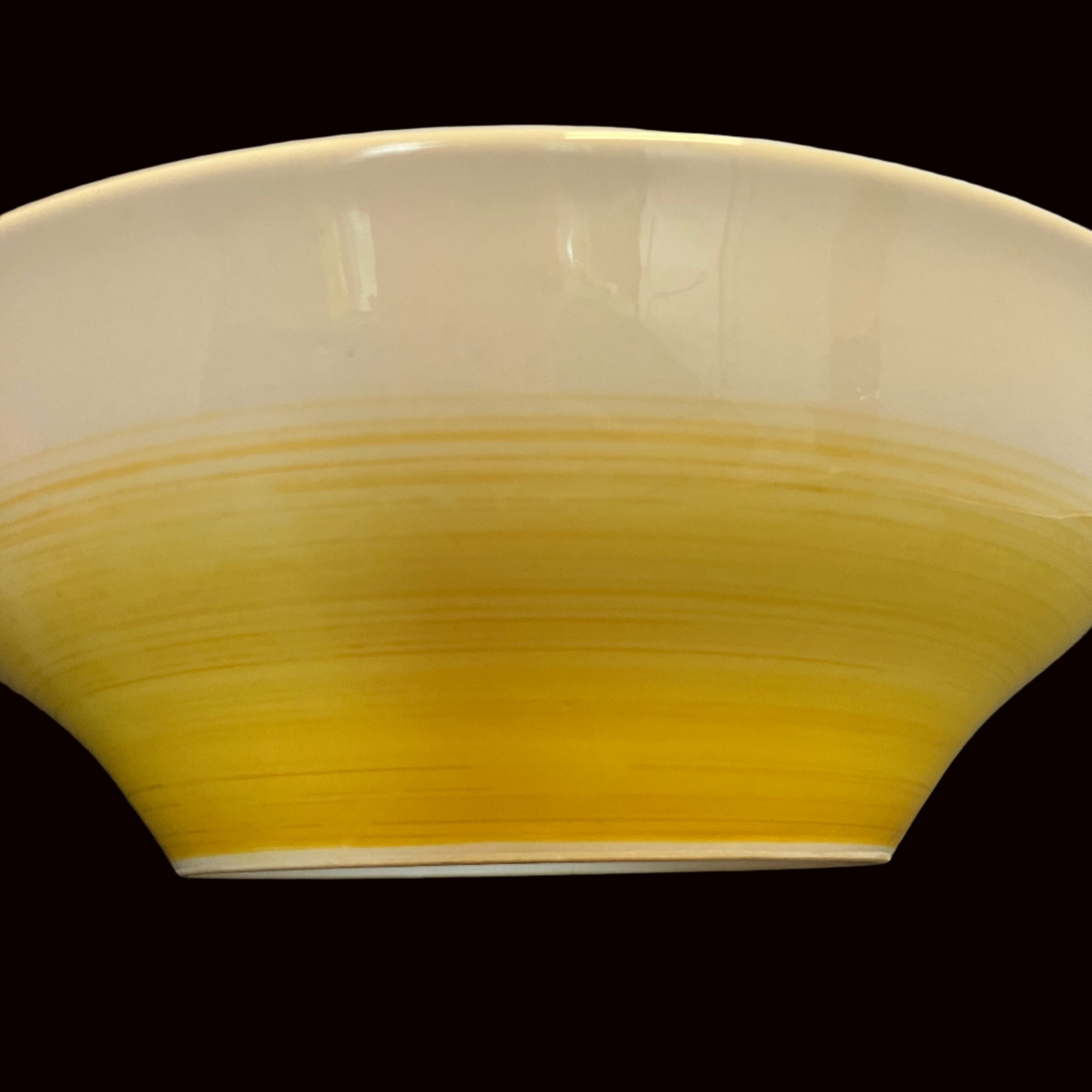 Yellow ceramic bowl on a white background