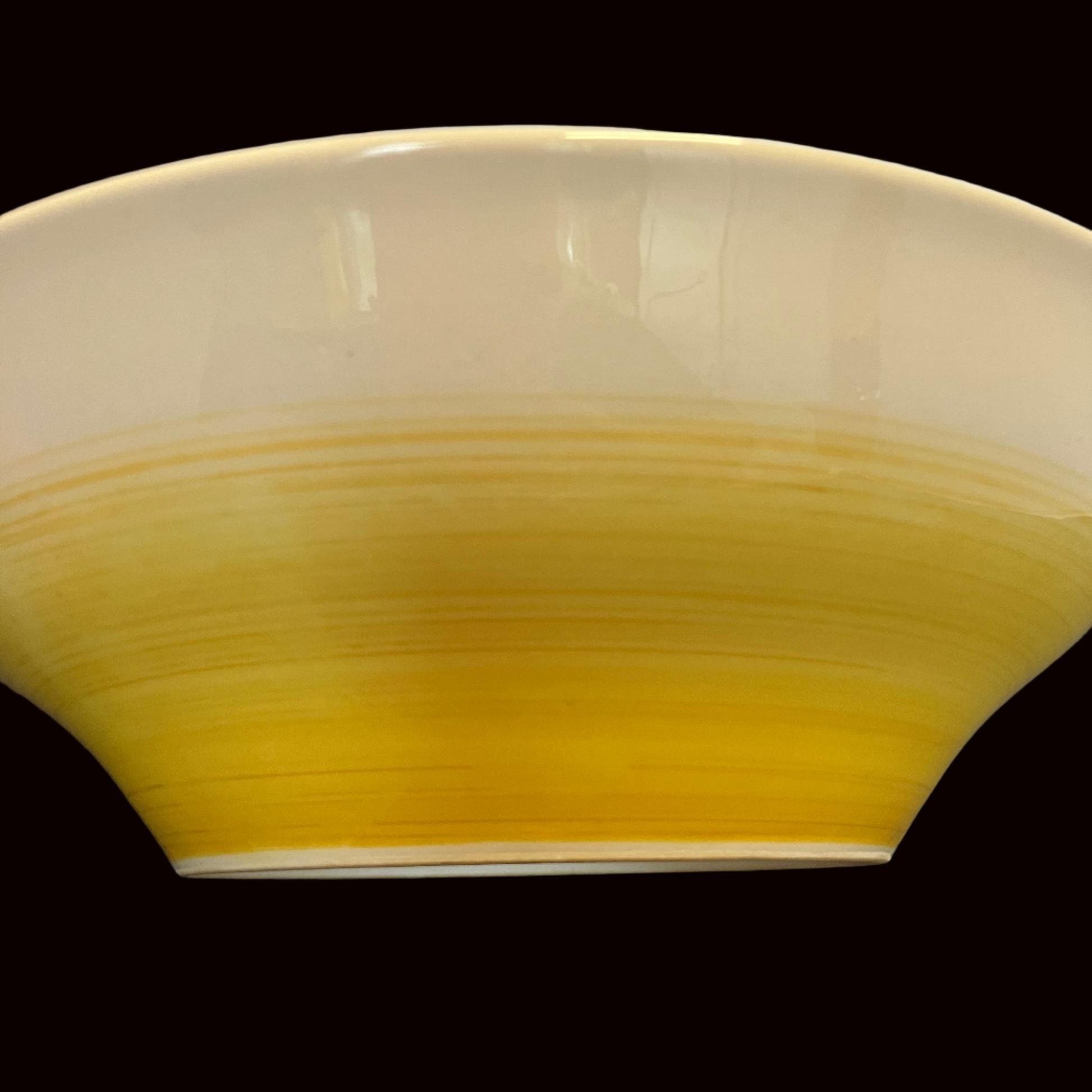 Yellow ceramic bowl on a white background