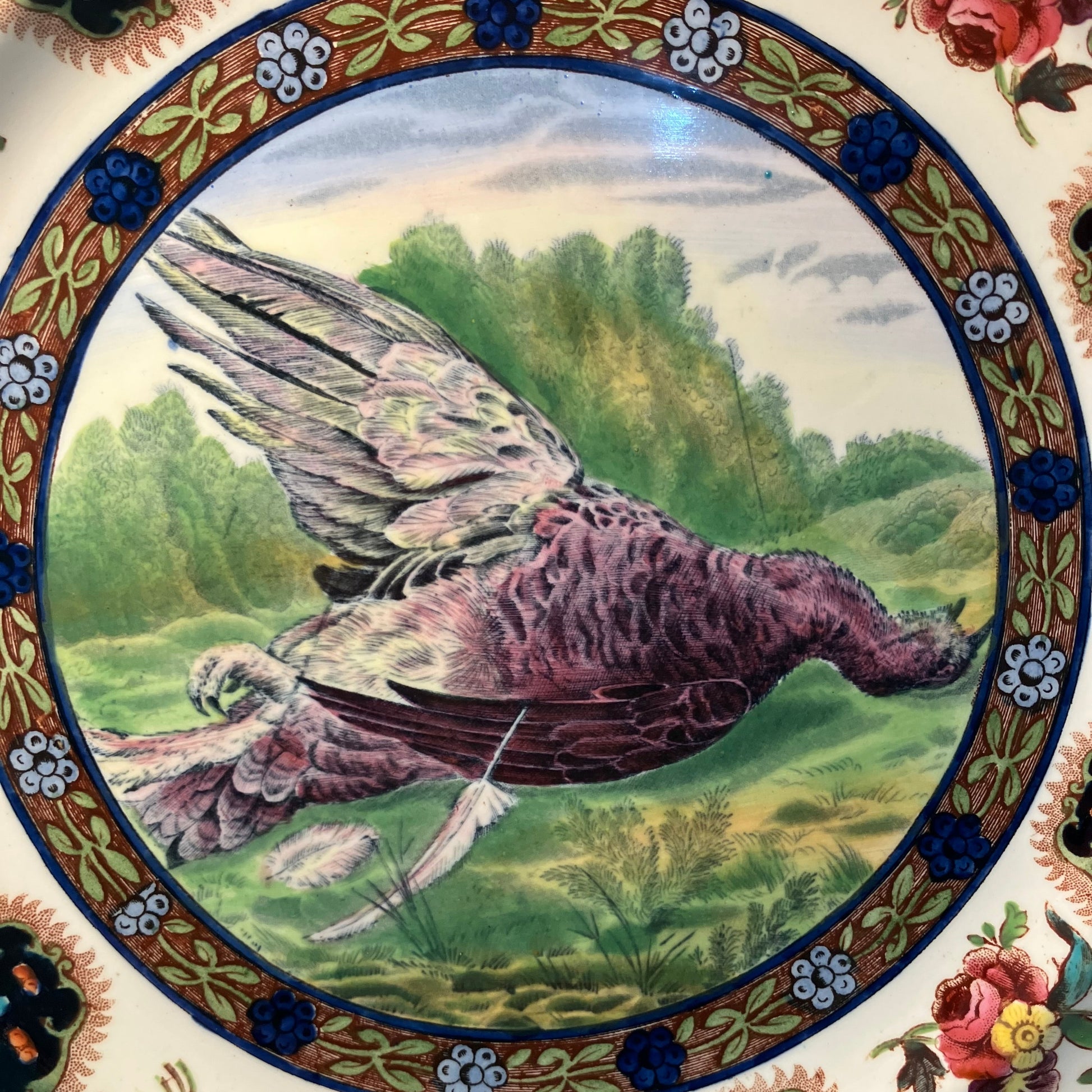 Decorative plate with a bird illustration and floral patterns