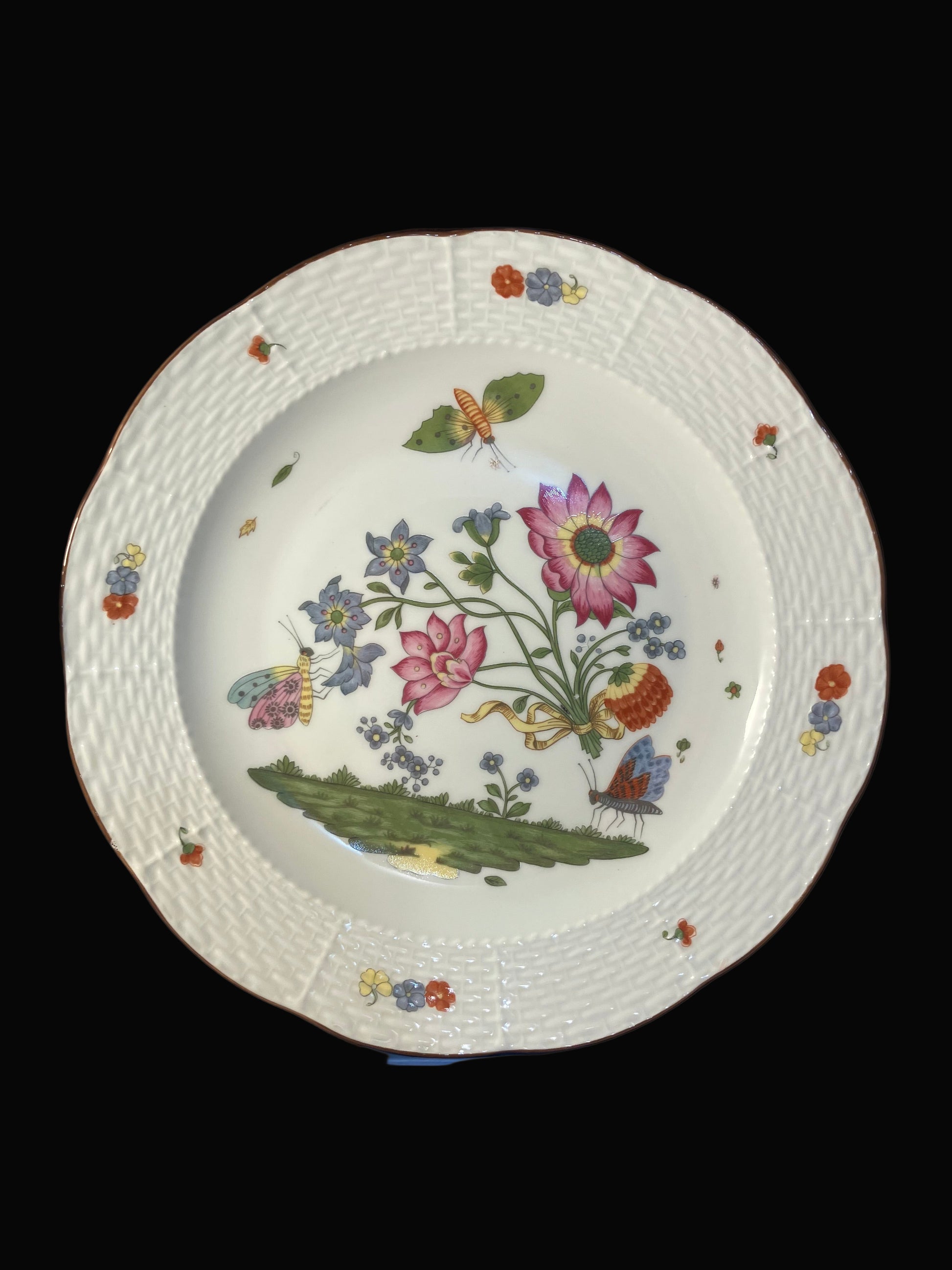 Decorative plate with floral and butterfly design on a white background