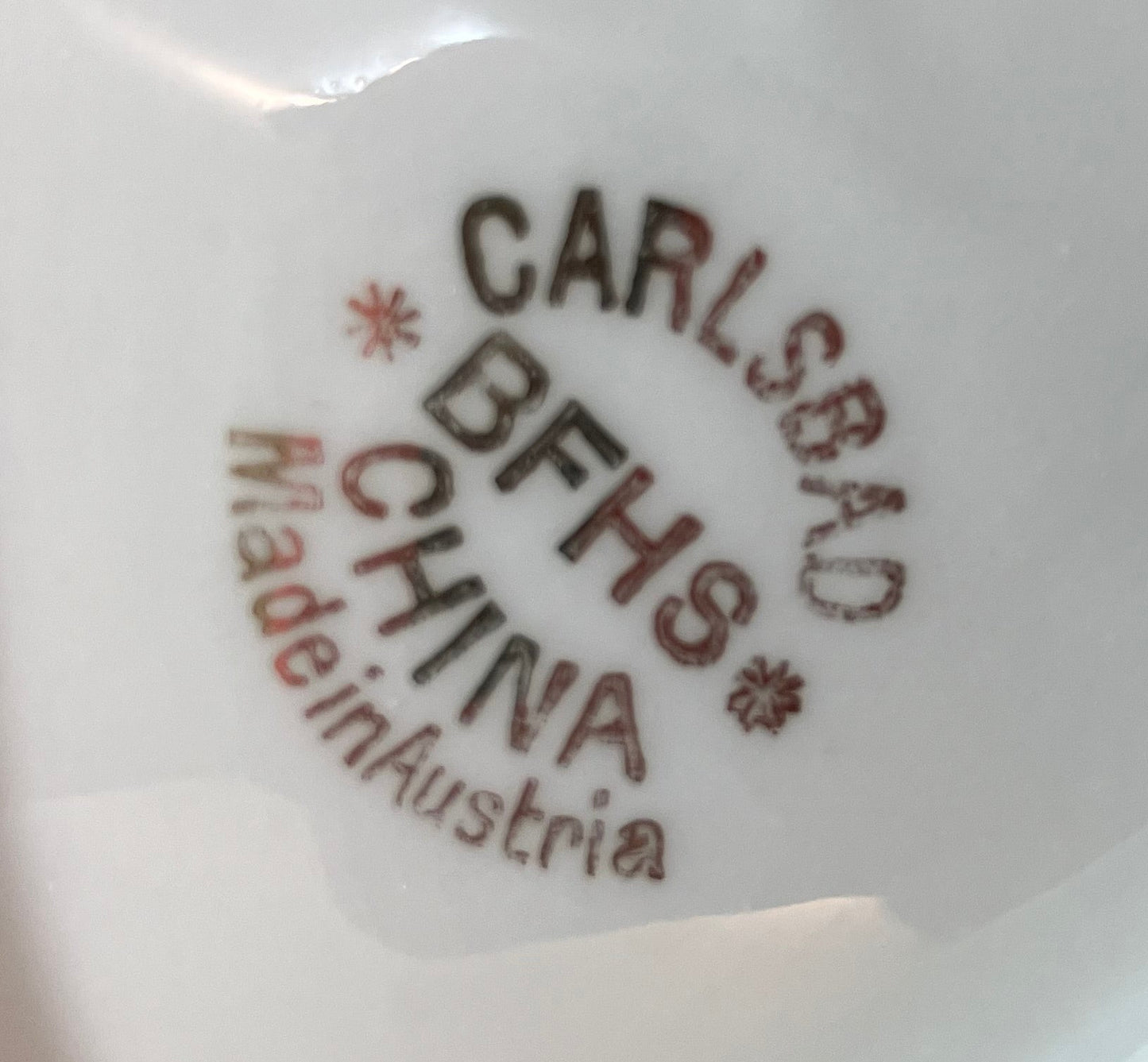 Stylized text 'CARLSBAD BFHS CHINA Made in Austria' on a white background