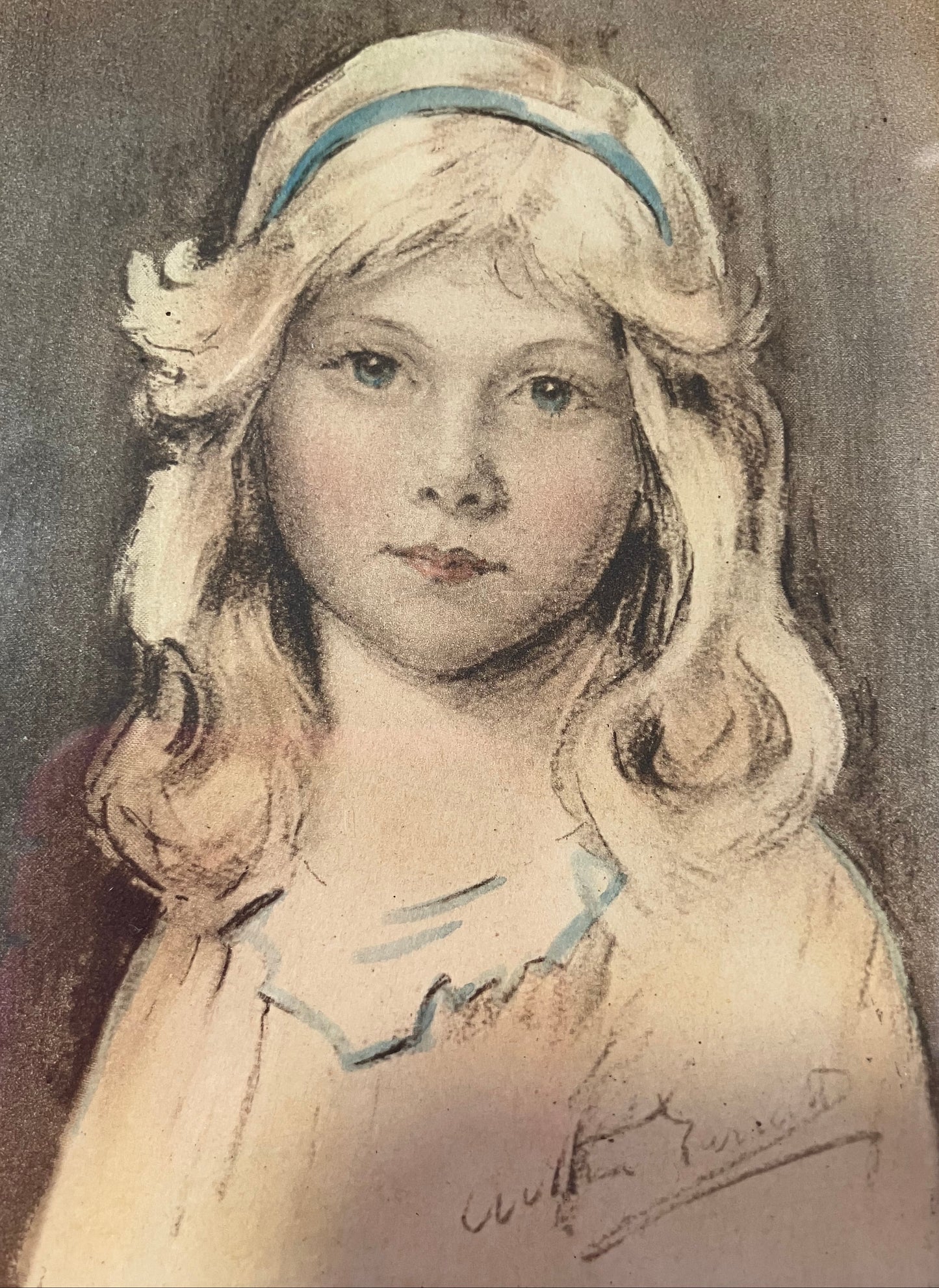 Portrait of a young girl with blonde hair and a blue headband