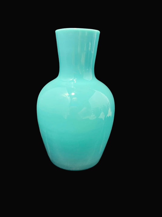 A glossy turquoise glass vase with a rounded body and a short flared neck, shown against a solid black background.