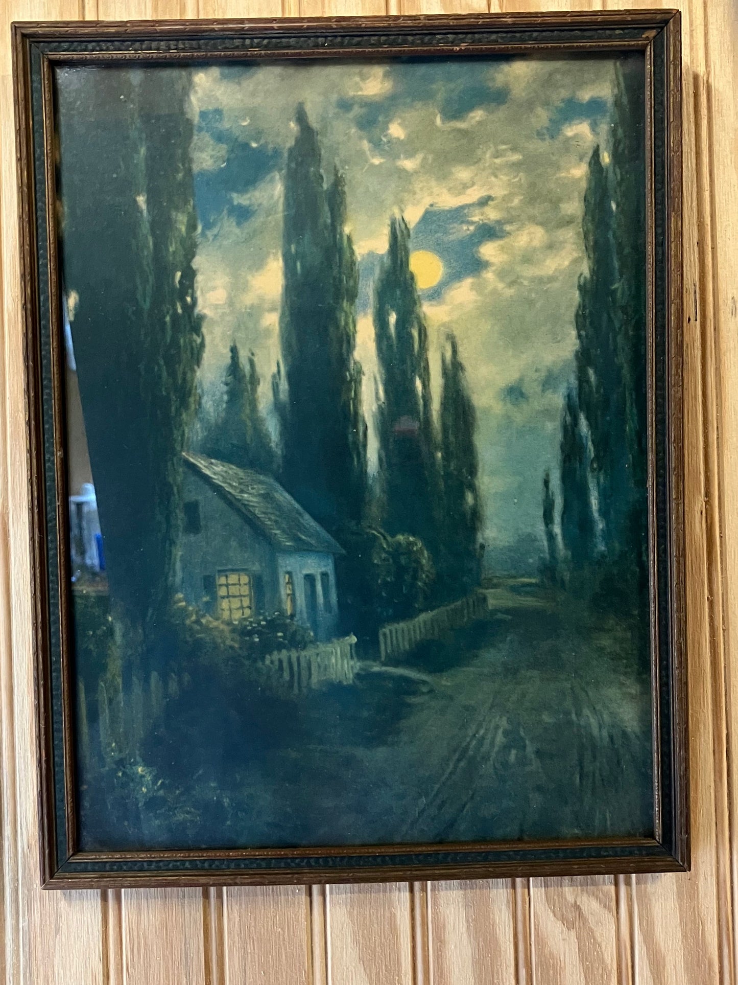 Framed painting of a house with trees 