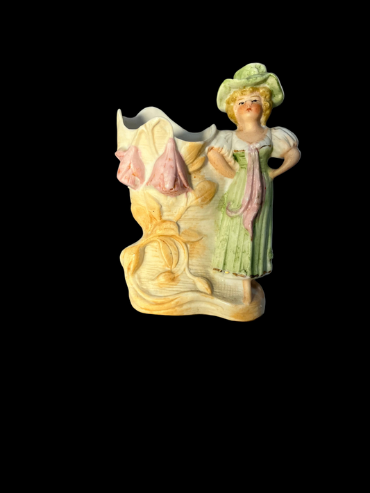 German bisque  vase featuring a woman in a hat with a floral design