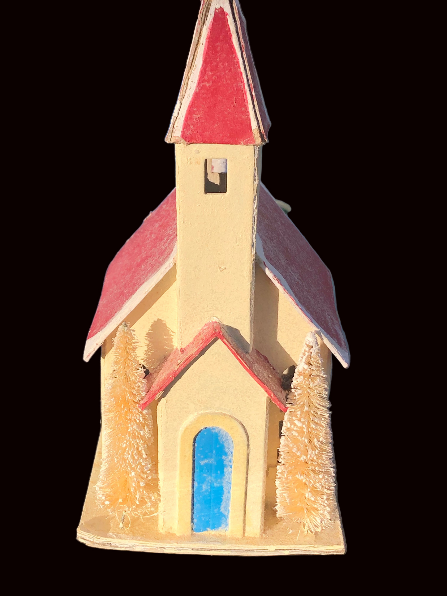 Small  Pultz style church with a red roof and blue door on a white base