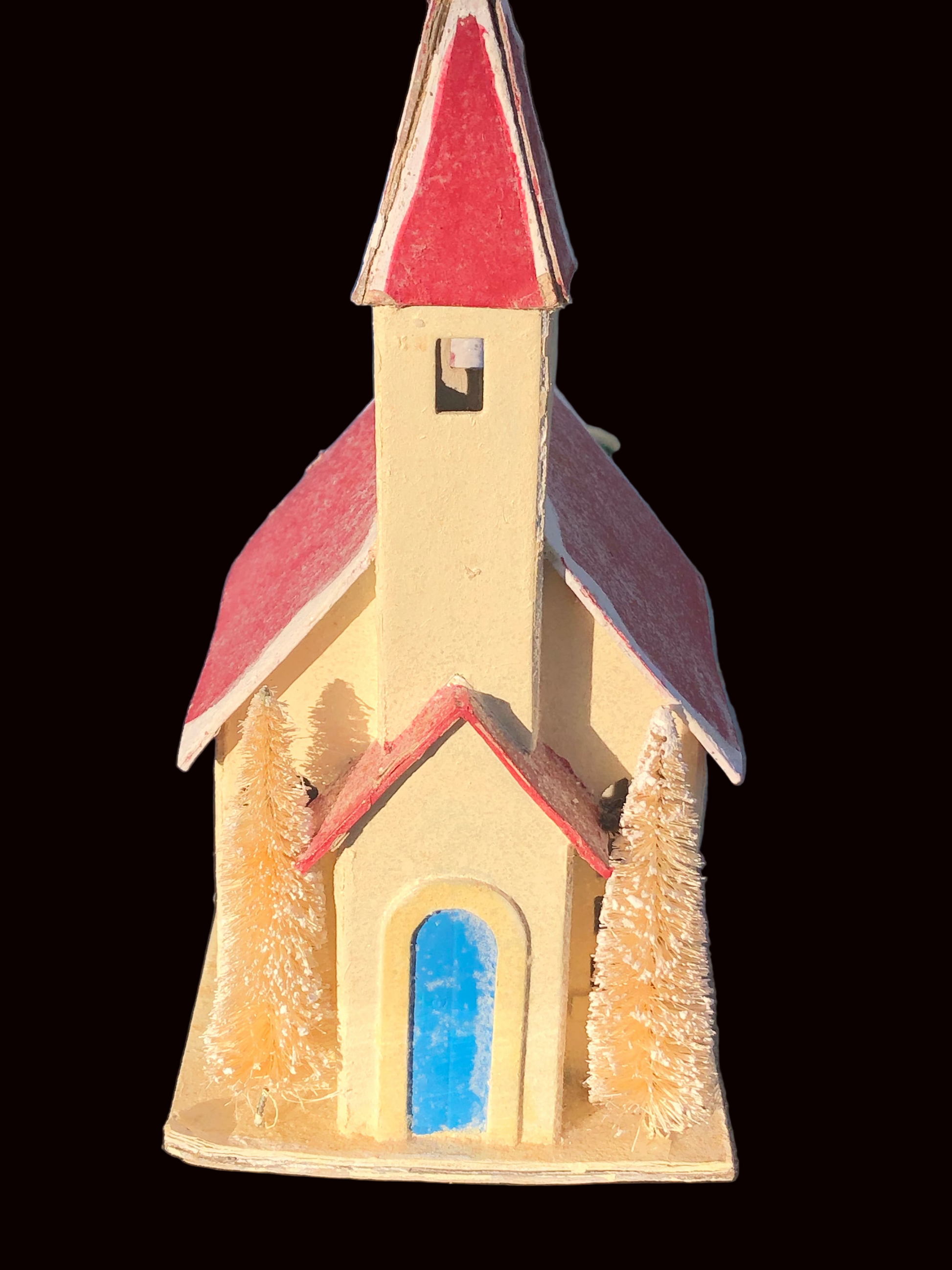 Small  Pultz style church with a red roof and blue door on a white base