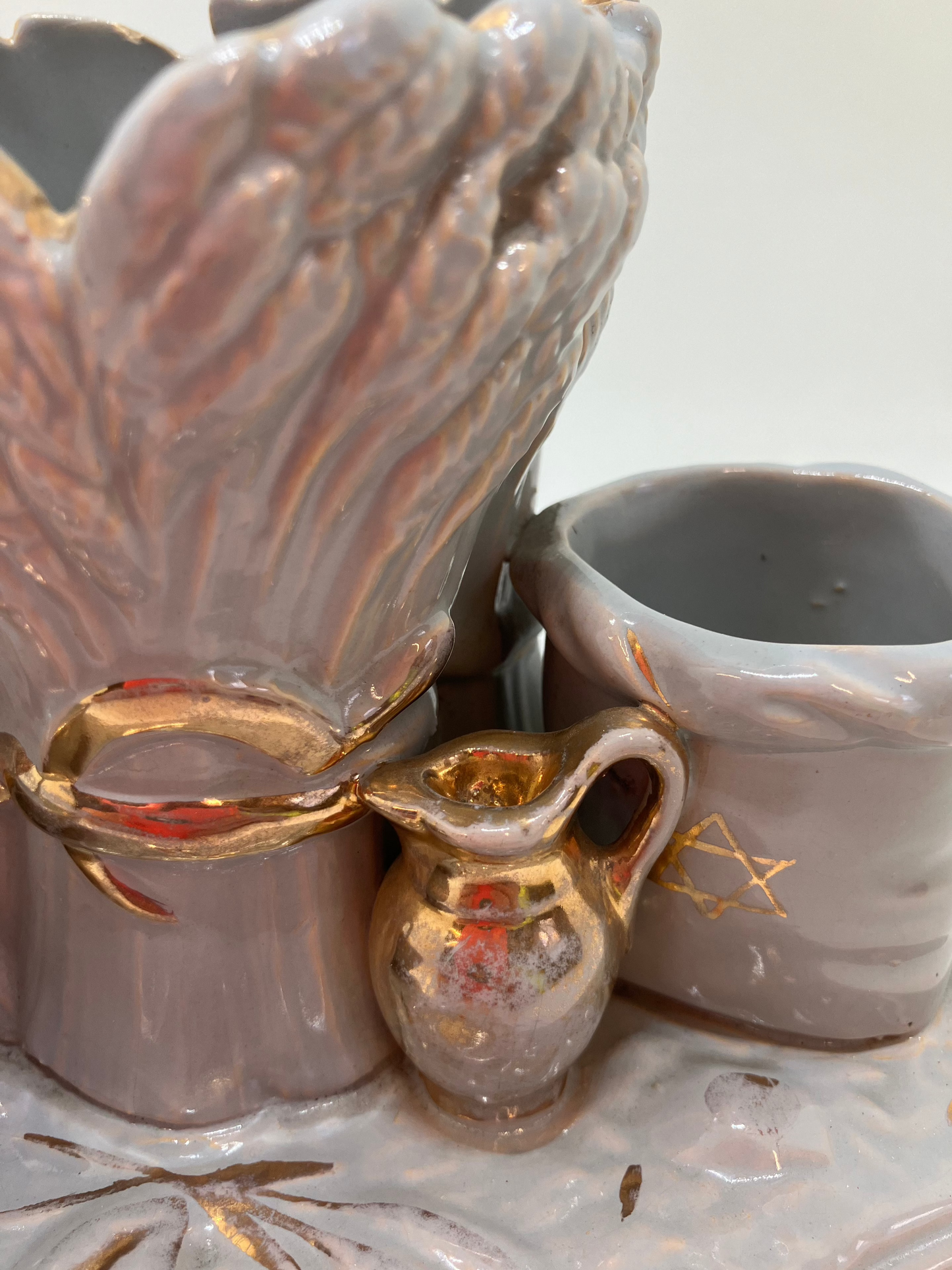 Sukkot ceramic piece featuring harvest items such as wheat, gathering basket, and jug. 