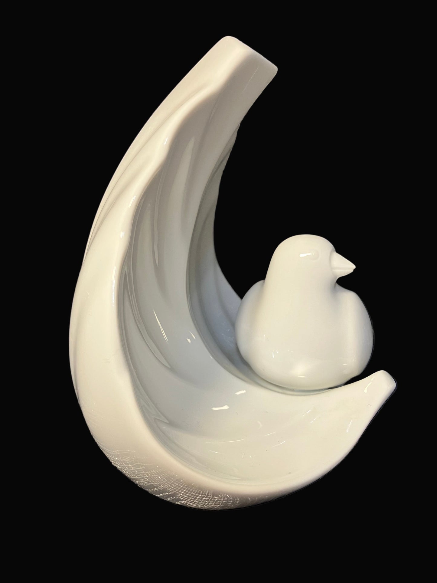 White ceramic sculpture of a bird on a curved branch against a black background